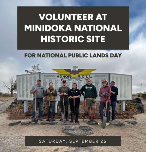 Group of eight volunteers with shovels posing in front of the Minidoka National Historic Site Honor Roll boards, promoting National Public Lands Day (Sept 26).